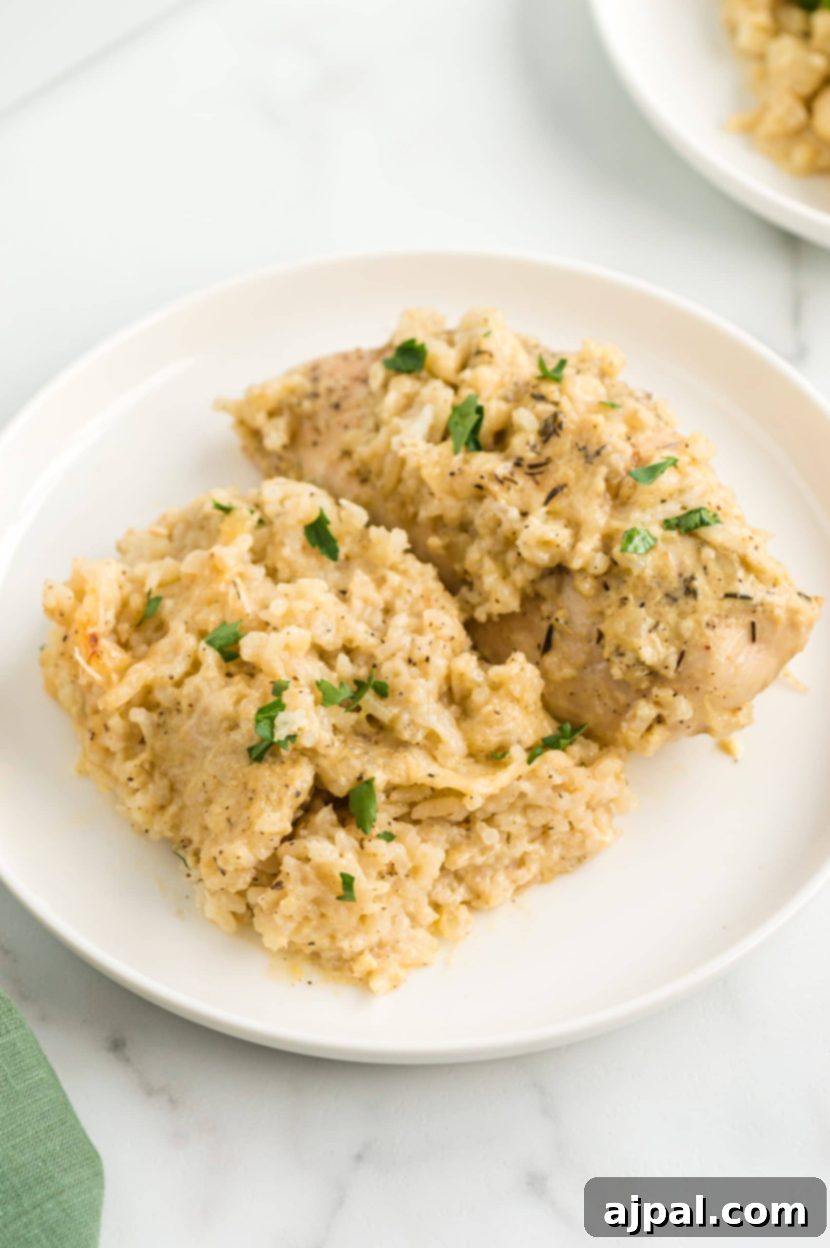 Simple Savory Chicken Bakes 6 A golden-baked one-pot chicken and rice dish, featuring juicy chicken pieces nestled in fluffy, seasoned rice, garnished with fresh herbs, ready to be served.