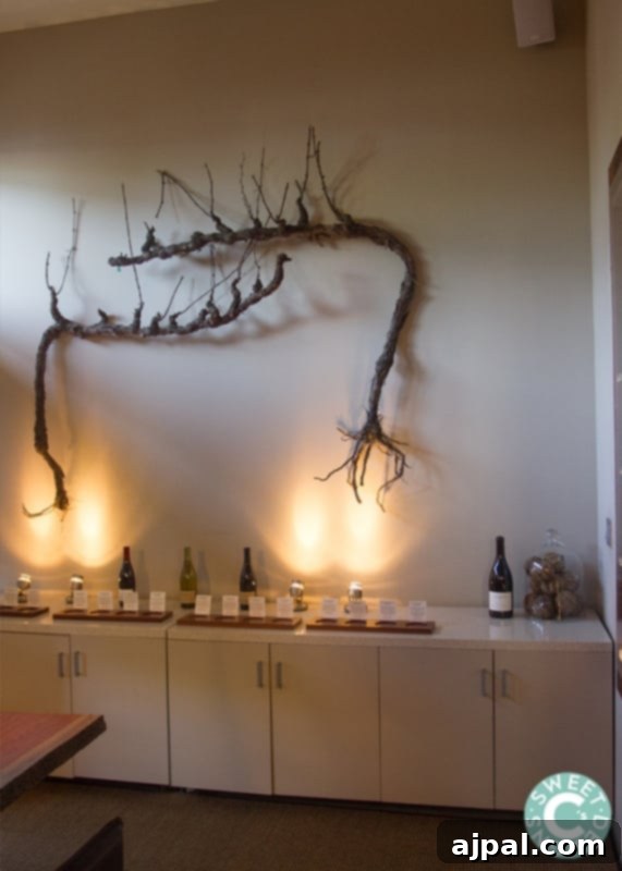 Interior of La Crema 9 Barrel Room adorned with wine bottles and decorative grapevines
