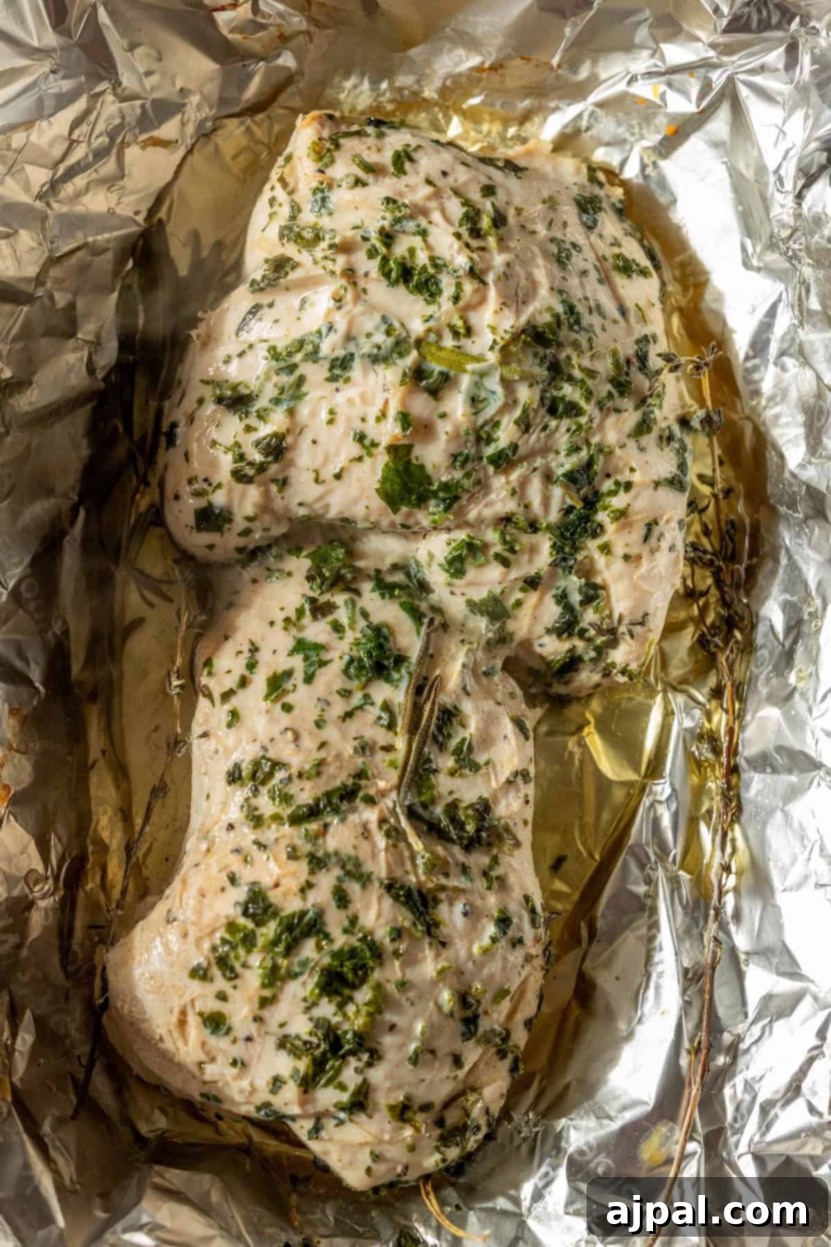 Cooked turkey tenderloins with juices in foil.