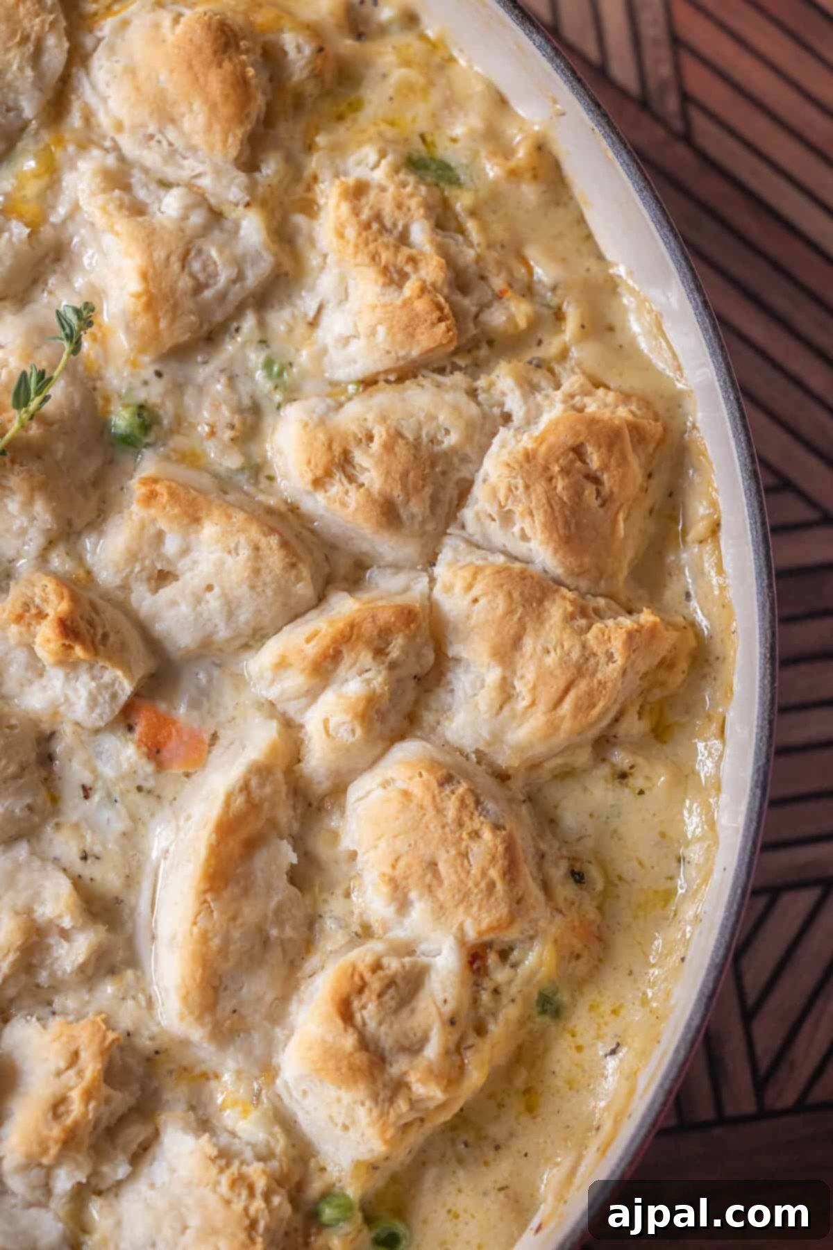 Baked turkey casserole topped with golden-brown biscuit pieces and a creamy filling with vegetables.