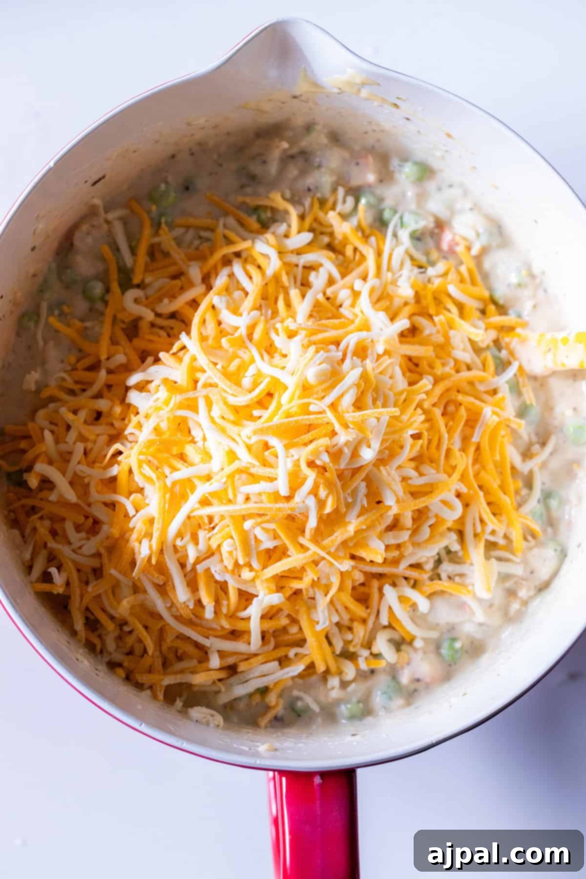 Creamy mixture of vegetables and leftover turkey topped with shredded cheddar cheese.