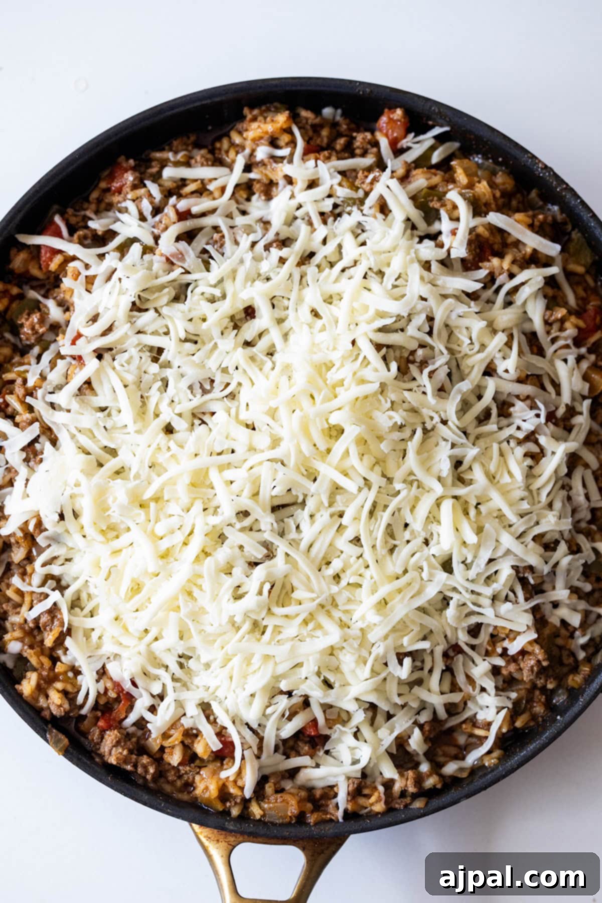 Fiery One-Pot Taco Skillet 9 A skillet filled with a ground meat and vegetable mixture, topped with shredded cheese, makes this One Pot Spicy Taco Rice Skillet an easy taco and rice skillet dinner, perfect for cooking or baking.