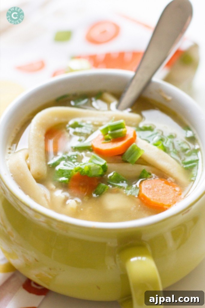 Quick & Easy Semi-Homemade Chicken Noodle Soup 4 A rustic bowl of semi-homemade chicken noodle soup, perfectly cooked noodles, chicken, and vegetables visible, highlighted by soft, natural light, ready to be enjoyed as a comforting meal.