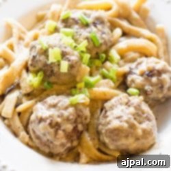 Swedish porcupine meatballs served in a white bowl with green onions.