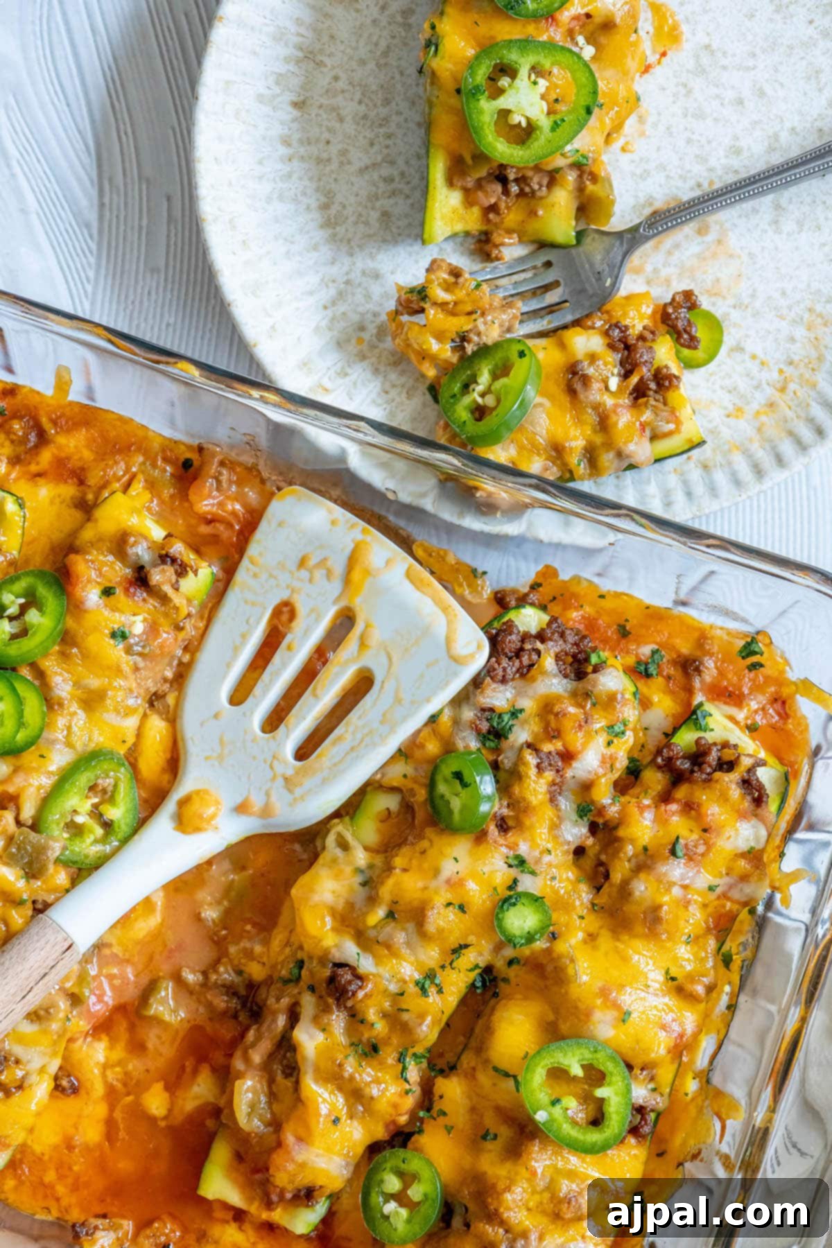 Baked Zucchini Treasures 14 Taco stuffed zucchinis baked in a glass dish with enchilada sauce and sliced jalapeños on top