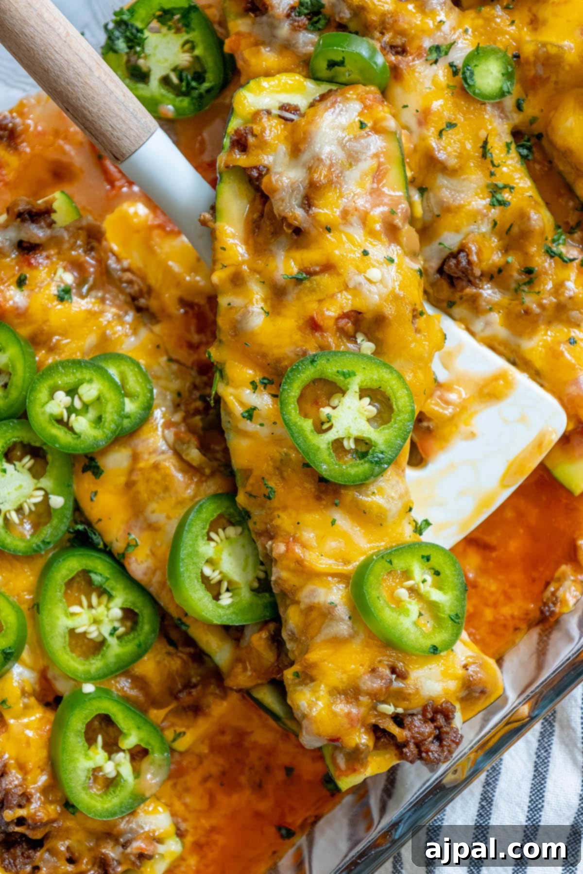 Baked Zucchini Treasures 4 Cheesy zucchini enchiladas with jalapenos in a baking dish.