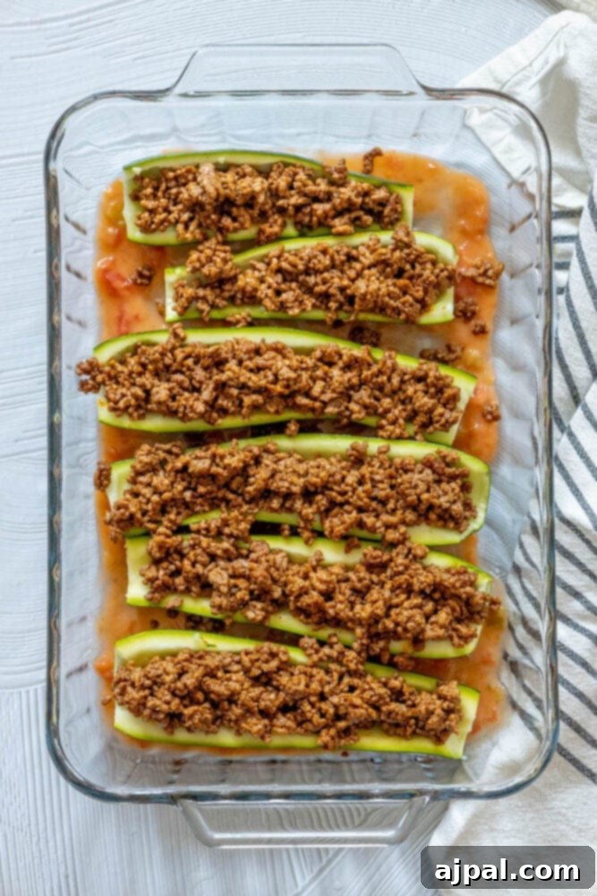 Baked Zucchini Treasures 9 Taco meat in zucchinis in a glass baking dish