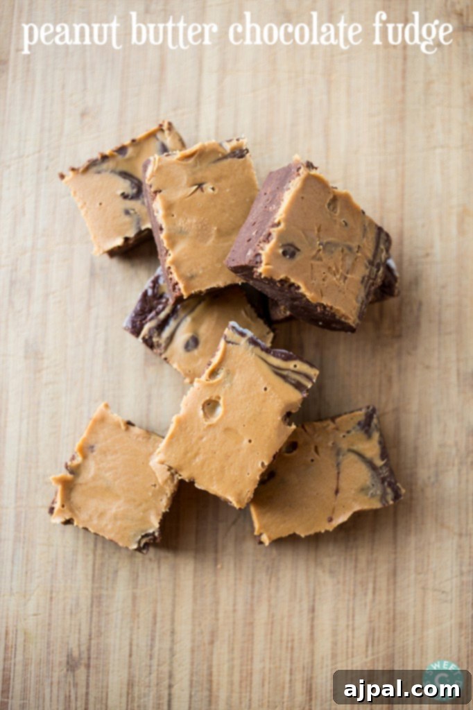 Chocolate Peanut Butter Fudge 2 peanut butter chocolate fudge cubes on a wooden cutting board