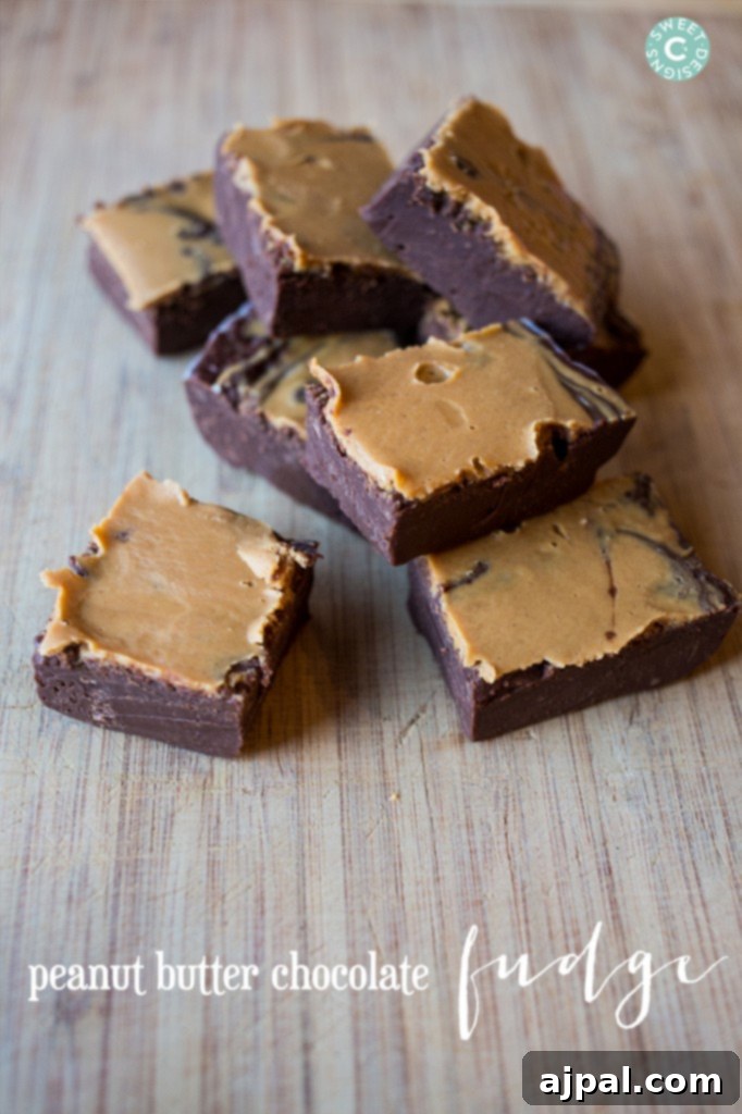 Chocolate Peanut Butter Fudge 4 peanut butter chocolate fudge cubes on a wooden cutting board