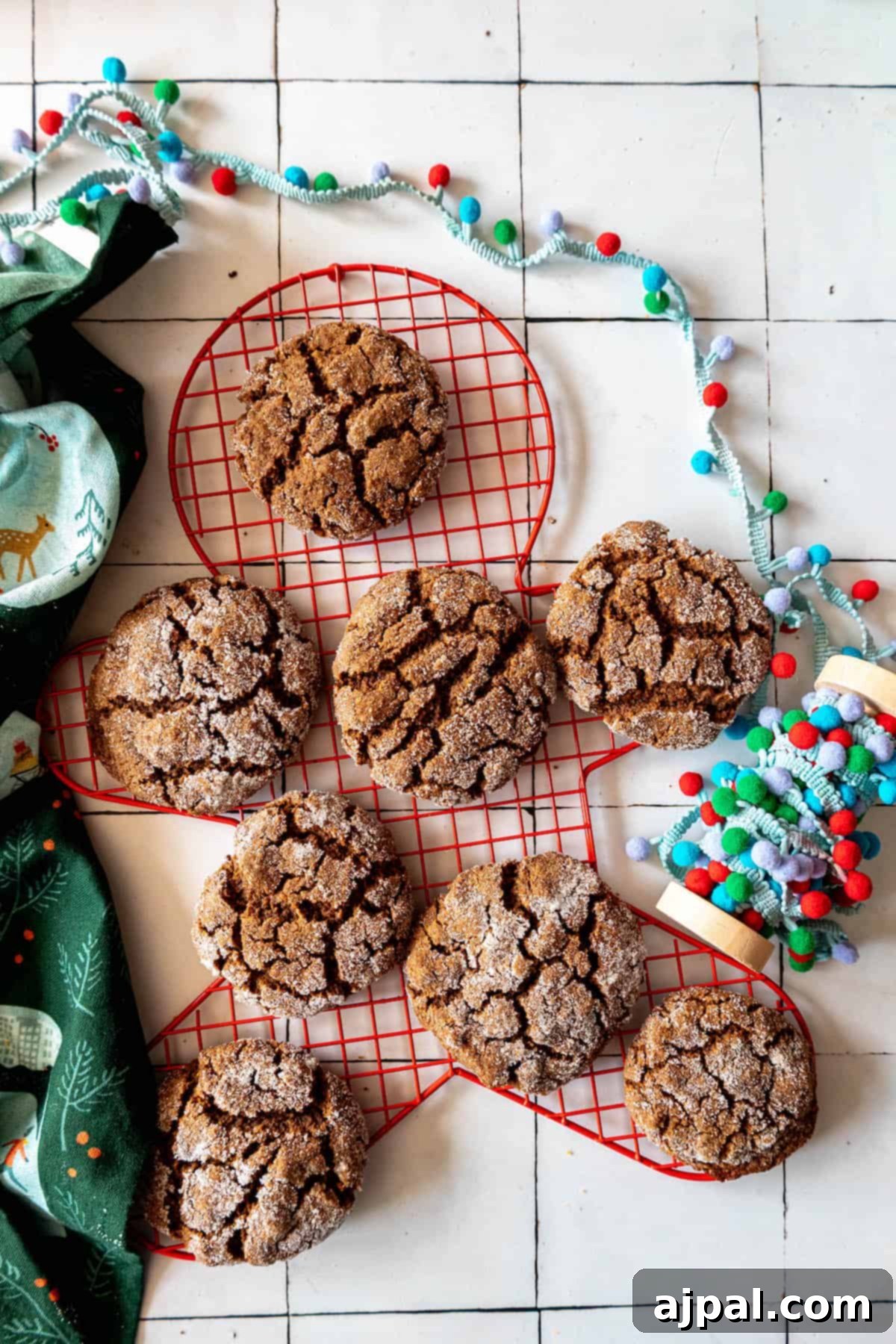 Spiced Molasses Chews 4 Soft gingersnap cookies on a cooling rack.