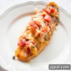 A simple plate with a baked fish.