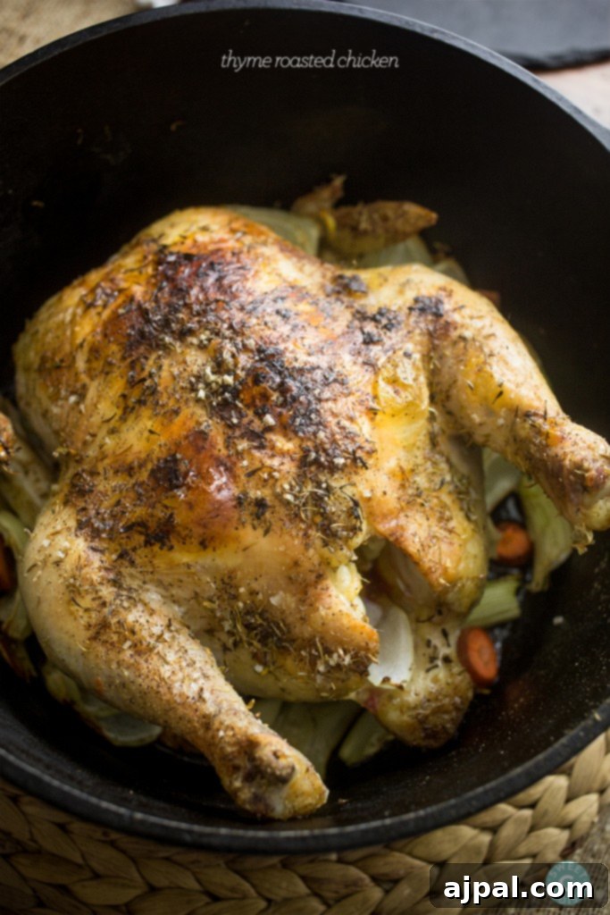 Perfect Thyme Roast Chicken 4 Roasted thyme-infused chicken with root vegetables cooking in a skillet, creating a comforting meal.