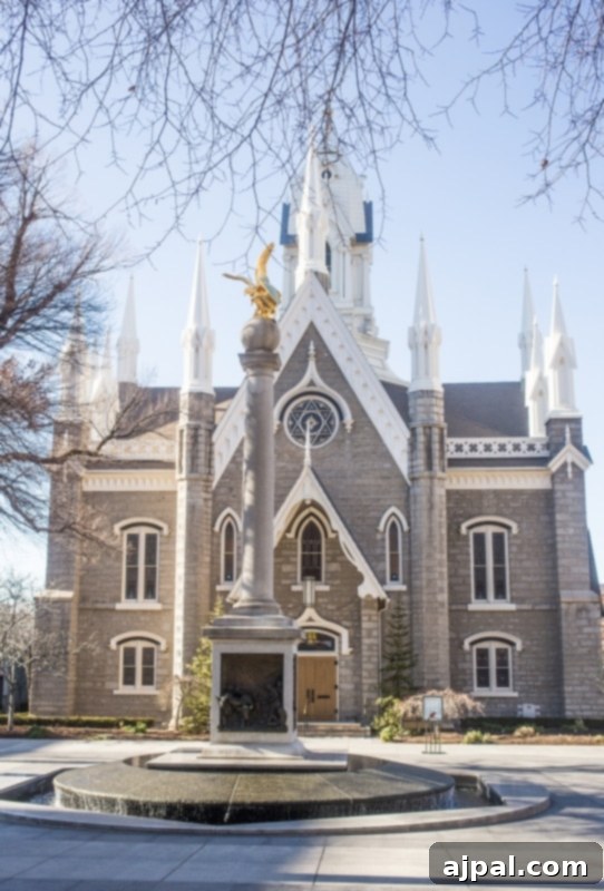 A grand church building with a large fountain in front, typical of Temple Square's beautiful architecture