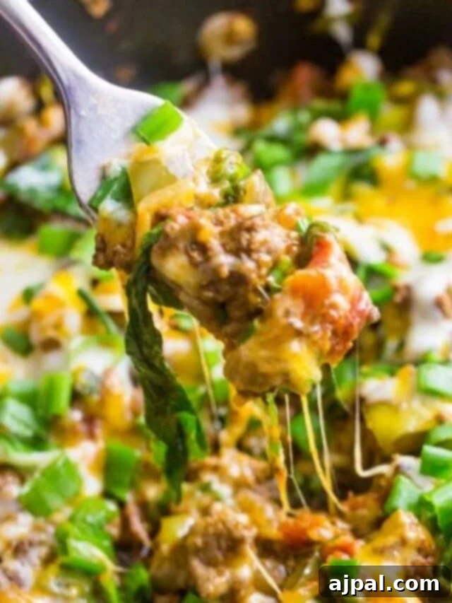 Loaded Cheesy Taco Skillet 12 picture of fork with ground beef taco mixture and cheese