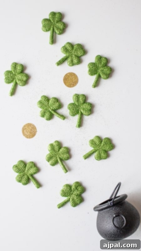 Charming St. Patrick’s Day iPhone Wallpaper with crochet shamrocks and a pot of gold.