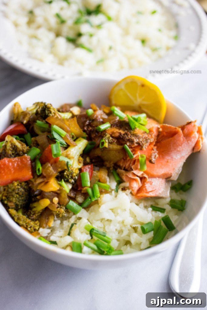 Paleo Salmon Taco Power Bowls 3 A vibrant bowl of Paleo salmon and vegetable taco bowls with cauliflower rice, showcasing a healthy and delicious meal option.
