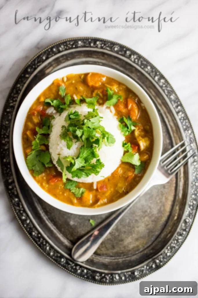 Smothered Langoustine 5 Langoustine Étouffée, a surprisingly easy and budget-friendly twist on a Creole classic, served elegantly on a plate with rice.