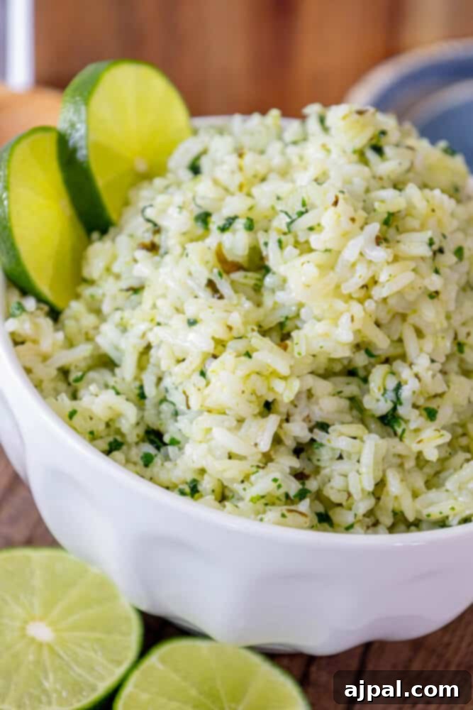 Zesty Chipotle Lime Rice 4 Lime rice in a white bowl with lime slices, Chipotle Knockoff.
