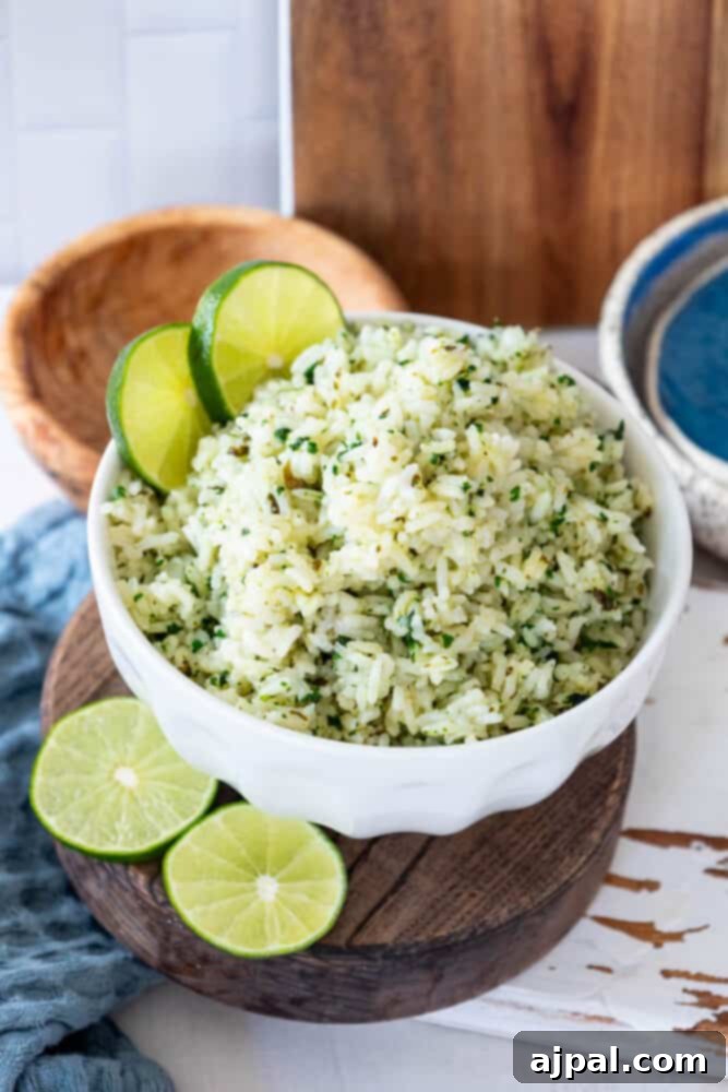 Zesty Chipotle Lime Rice 5 Cilantro lime rice in a white bowl with lime slices.