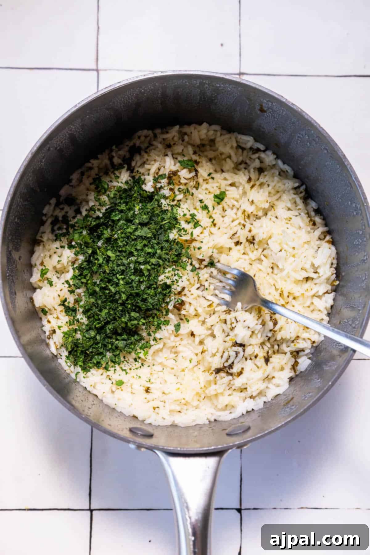 Zesty Chipotle Lime Rice 8 A frying pan filled with Chipotle Knockoff Cilantro Lime Rice.