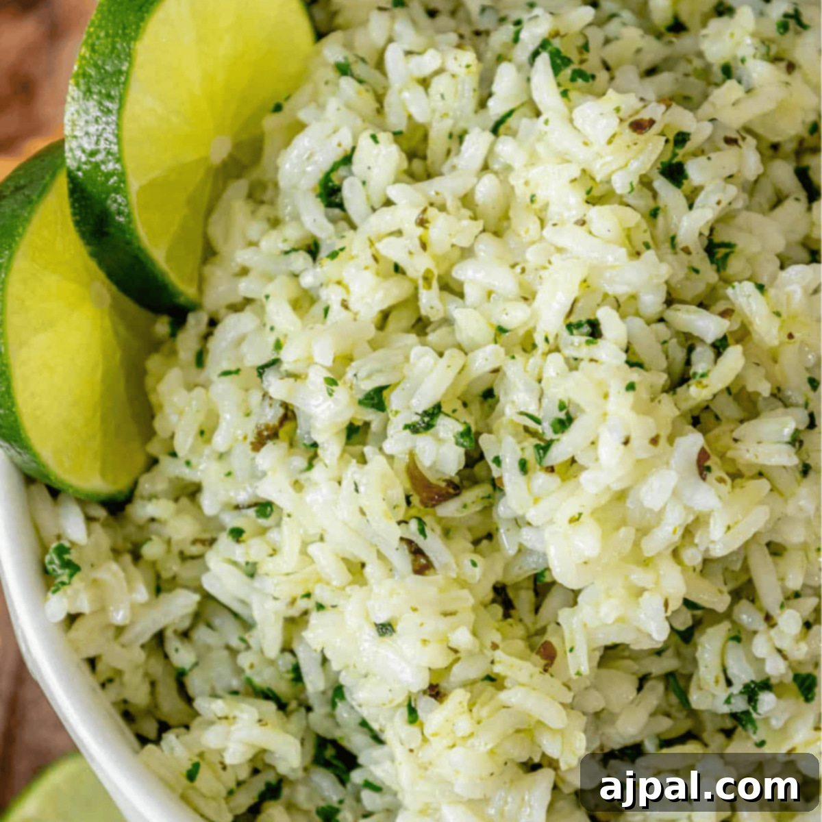 Zesty Chipotle Lime Rice 10 Close-up of a bowl of cilantro lime rice garnished with lime slices.