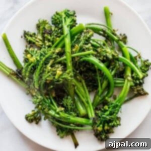 picture of pan fried broccolini on a white plate