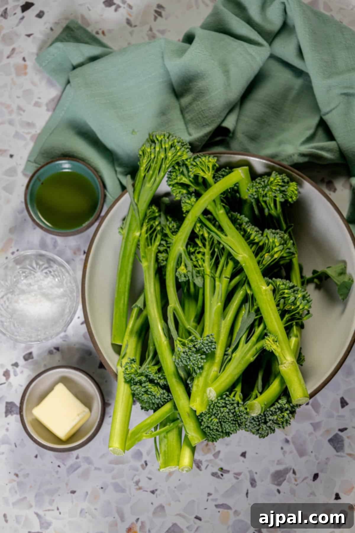 Sauteed broccolini with butter, served in a bowl on a table, highlighting the rich ingredients.