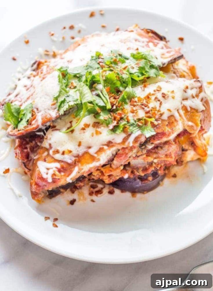 Keto eggplant lasagna on a white plate, ready to be enjoyed.