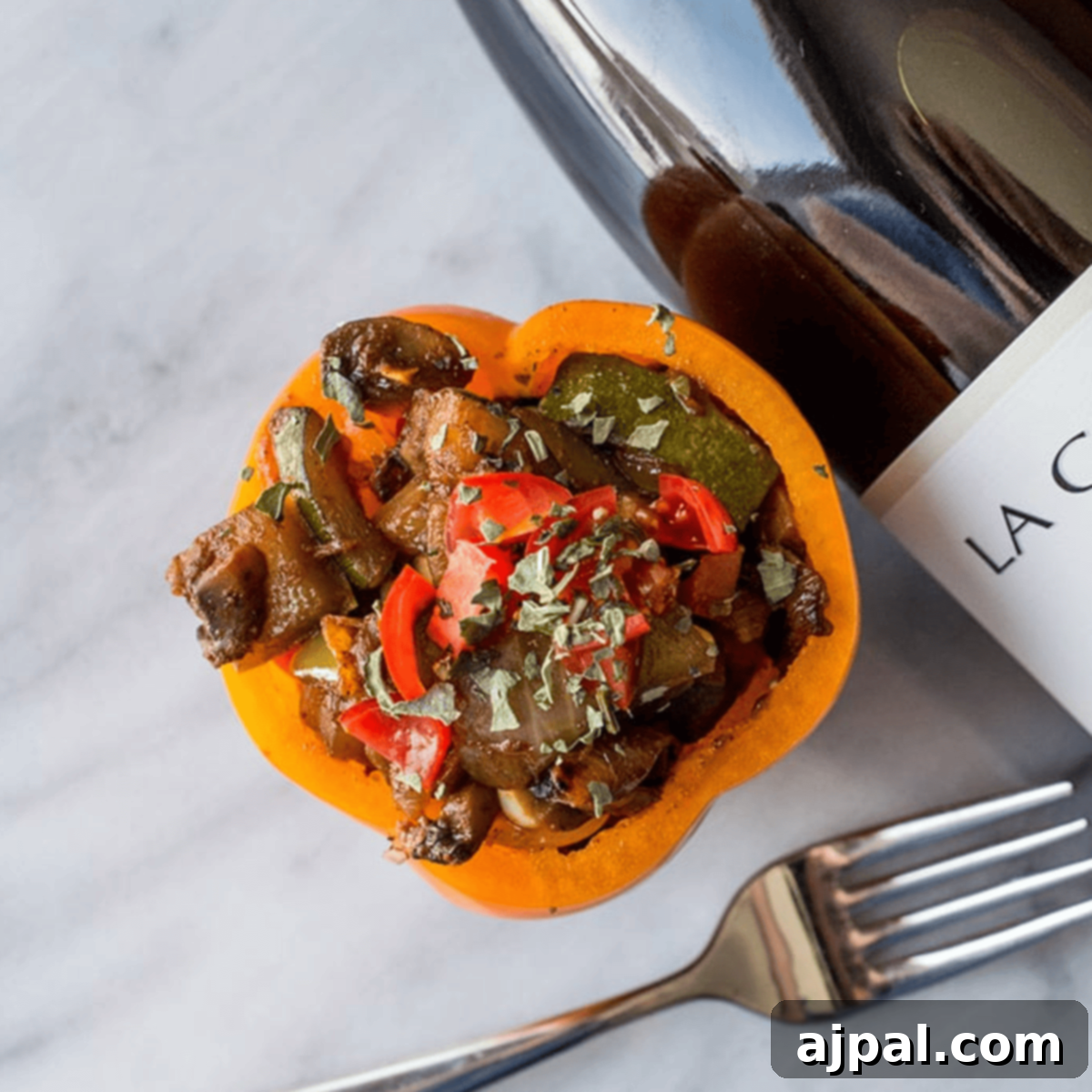 Fiery Plant-Based Stuffed Peppers 3 bell pepper with sauteed vegetables in it and wine in the background