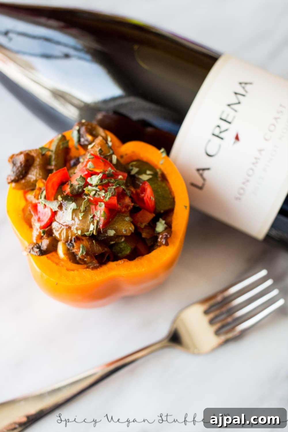 Fiery Plant-Based Stuffed Peppers 5 bell pepper with sauteed vegetables in it and wine in the background