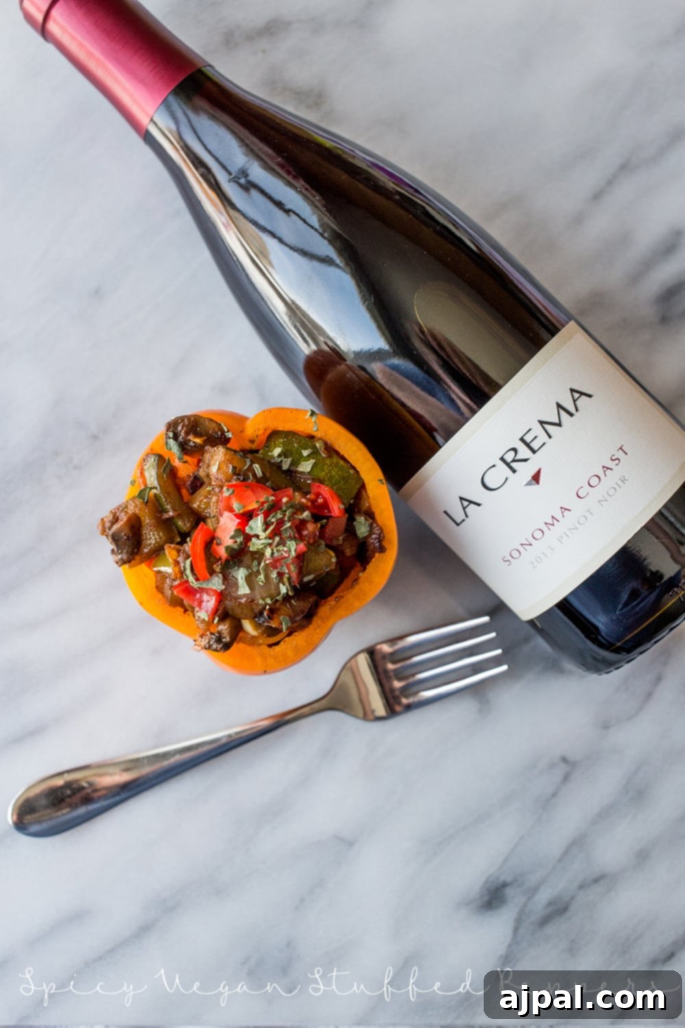 Fiery Plant-Based Stuffed Peppers 6 bell pepper with sauteed vegetables in it and wine in the background