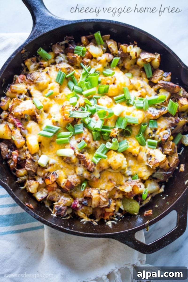 Crispy cheesy veggie home fries in a cast iron skillet, topped with fresh green onions.