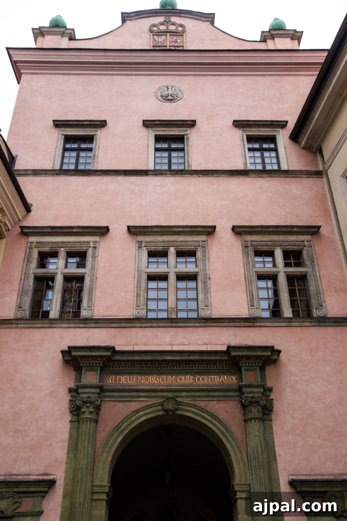 Discovering Krakow's Wawel Castle and Cathedral 15 Vibrant pink building within Krakow’s Wawel Castle, highlighting the colorful architecture