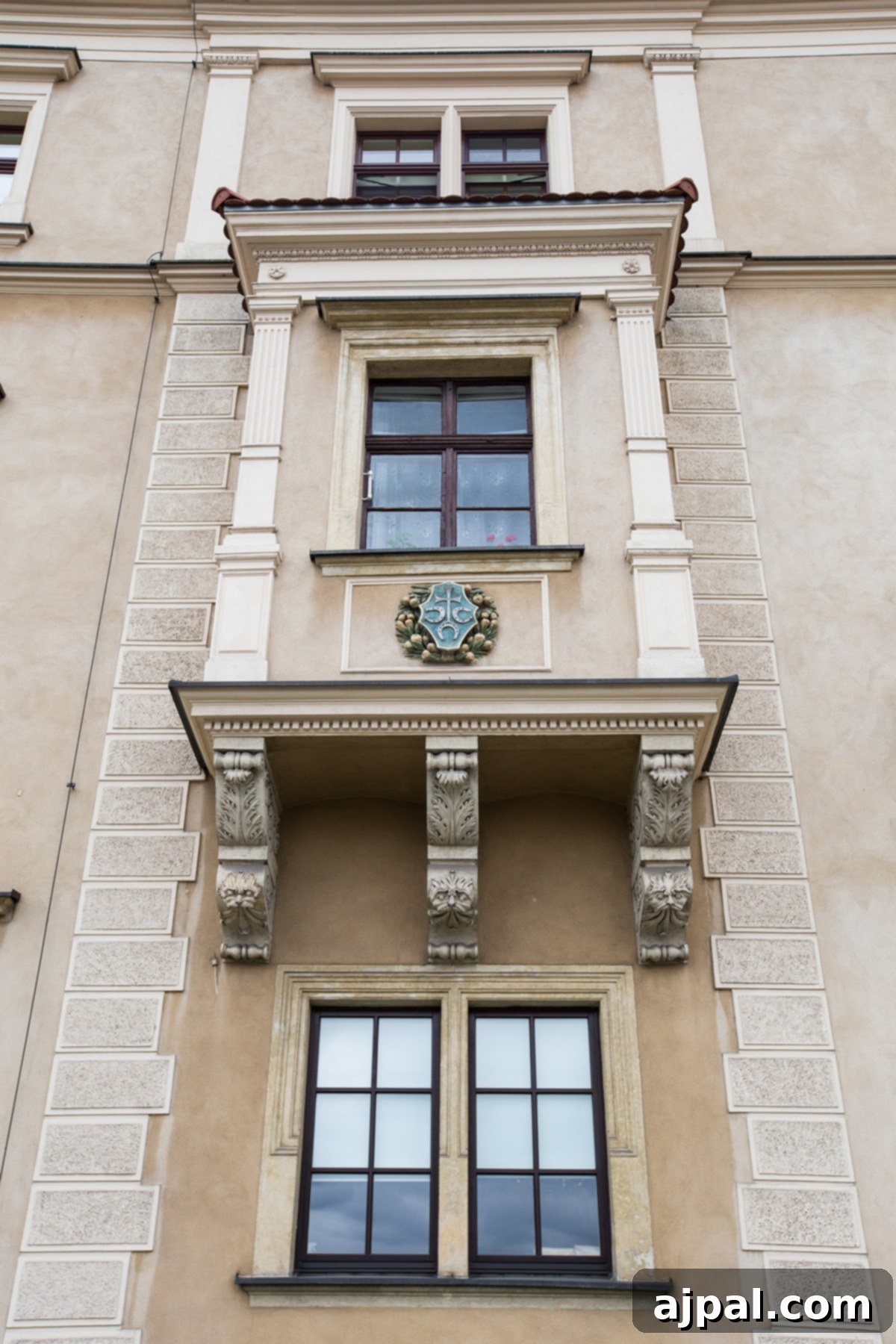 Discovering Krakow's Wawel Castle and Cathedral 16 Intricate architectural detailing on the exterior of apartments at Wawel Castle in Krakow, featuring a prominent clock tower
