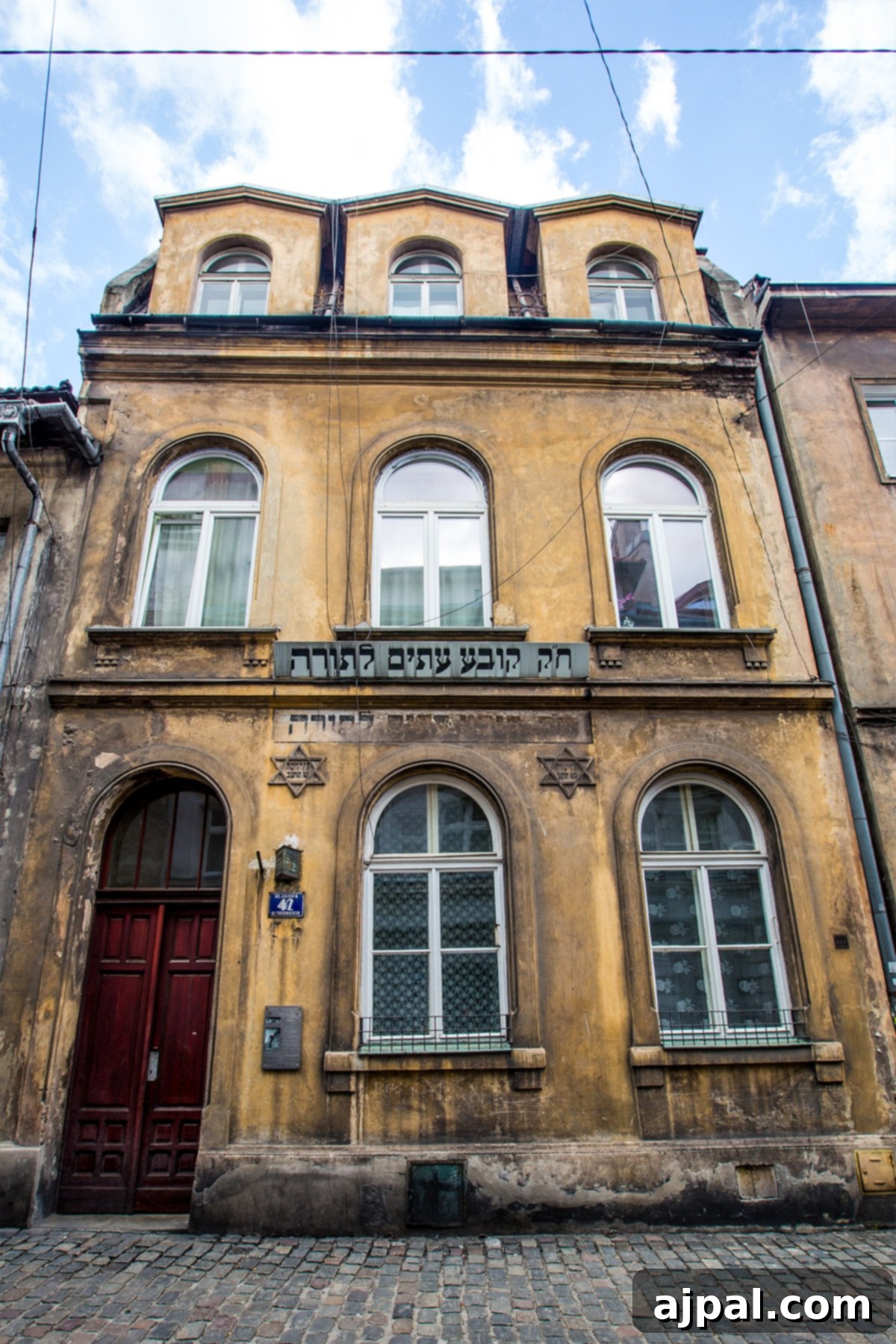 Historic building with a striking red door in Kazimierz, Krakow's Jewish District