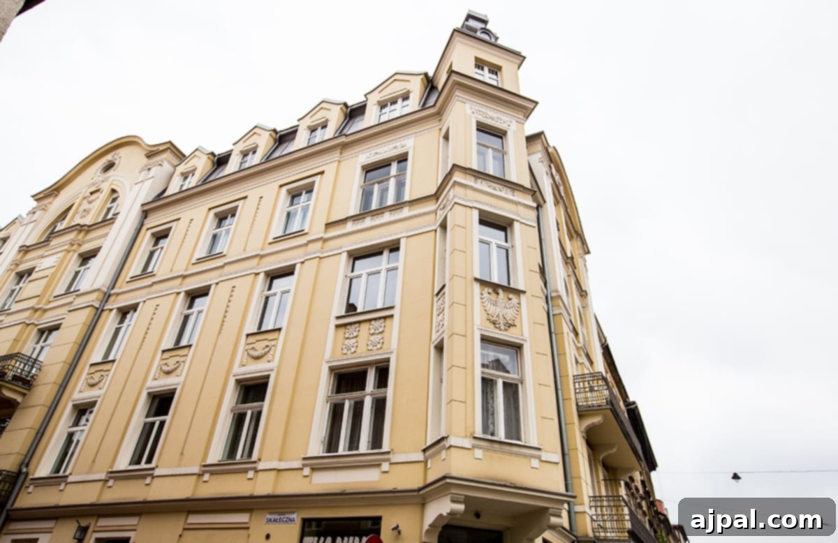 A beautiful yellow building with a prominent clock tower in Kazimierz, Krakow’s Jewish District, showcasing its unique architectural charm.
