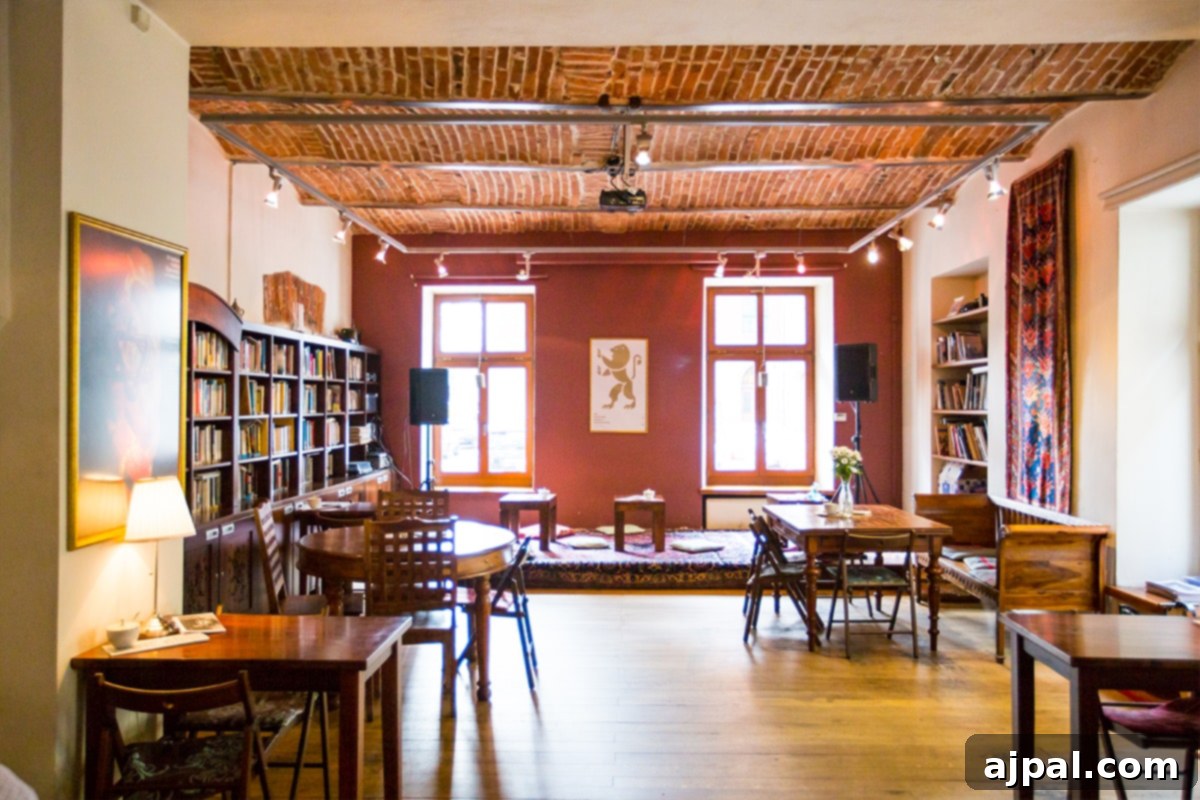 Cozy Cheder Cafe interior in Krakow's Jewish District, with bookshelves and a fireplace