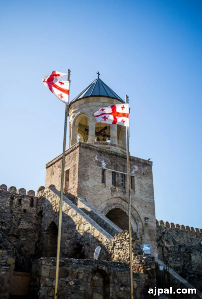 Georgian Supra: A Toast to Wine and Tradition 5 Georgian Flag proudly flying outside a historic cathedral in Mtskheta, Georgia, symbolizing national pride and heritage