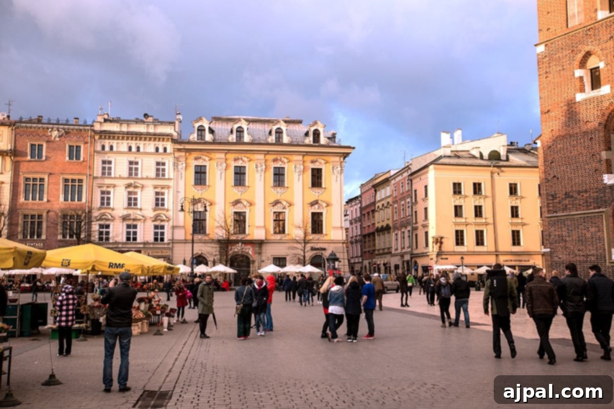 Krakow: Poland's Royal City 2 People walking in Krakow Main Square, vibrant with flower vendors and cafes at sunset.