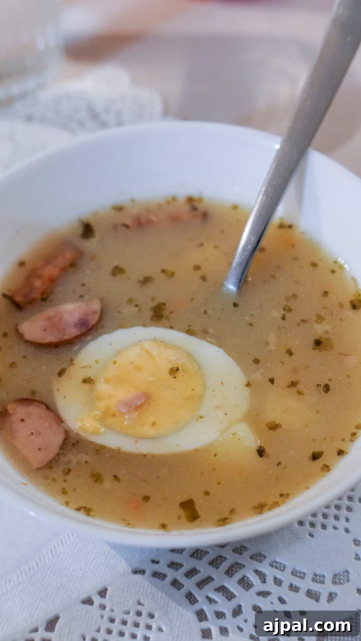 Krakow: Poland's Royal City 4 A hearty Polish soup with sausages and a boiled egg, served in a rustic bowl.