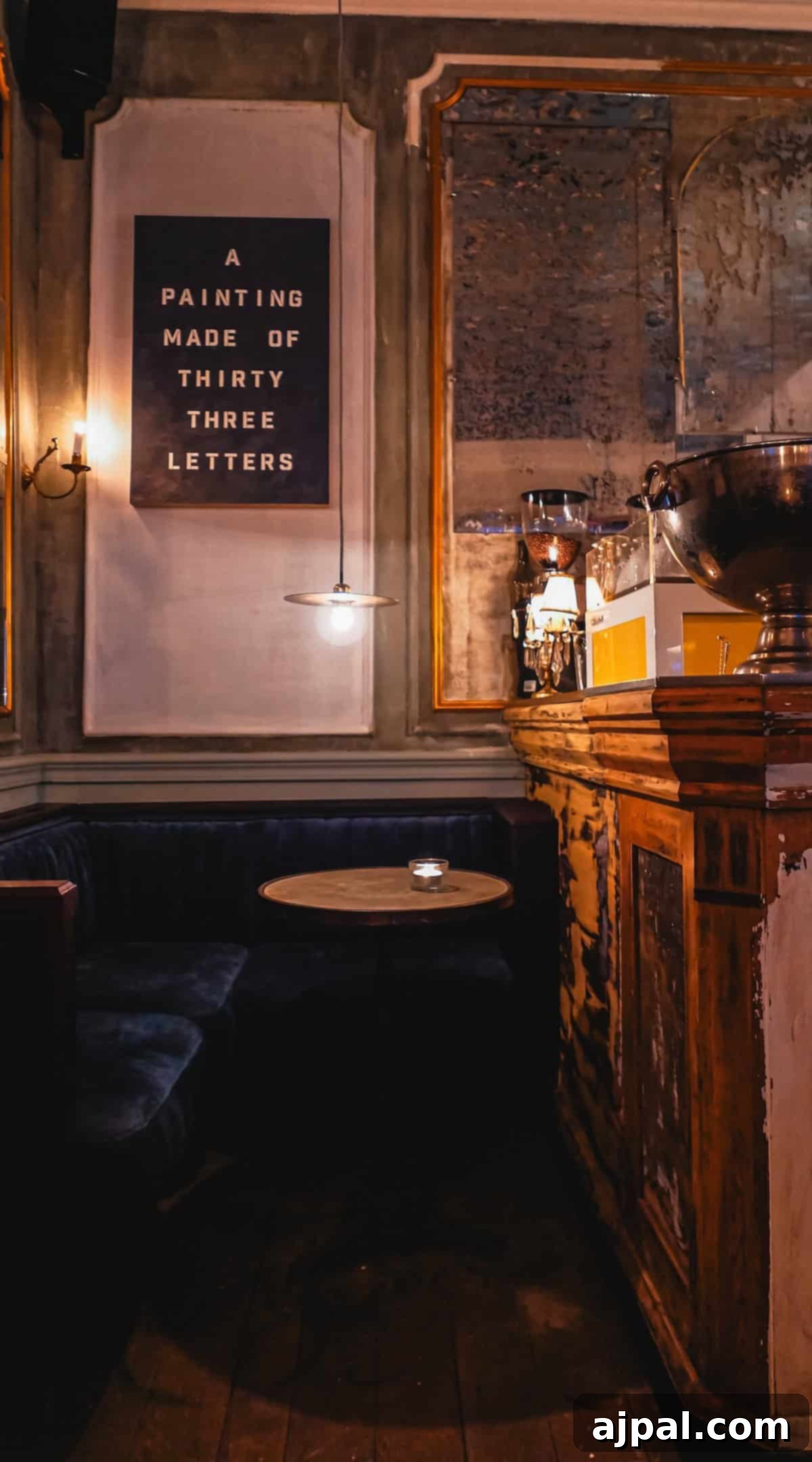 Krakow: Poland's Royal City 7 A cozy bar corner in Krakow with cushioned seating and a sign reading "A PAINTING MADE OF THIRTY THREE LETTERS.