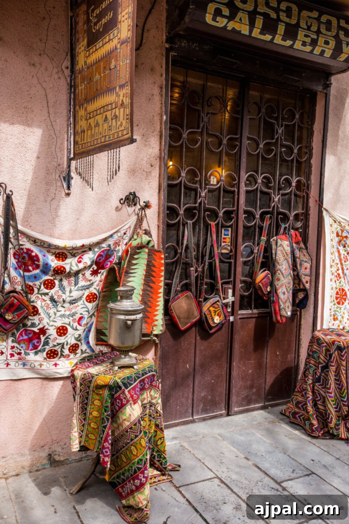 A colorful shop in Tbilisi's Old Town displaying vibrant textiles, traditional clothing, and Georgian crafts.