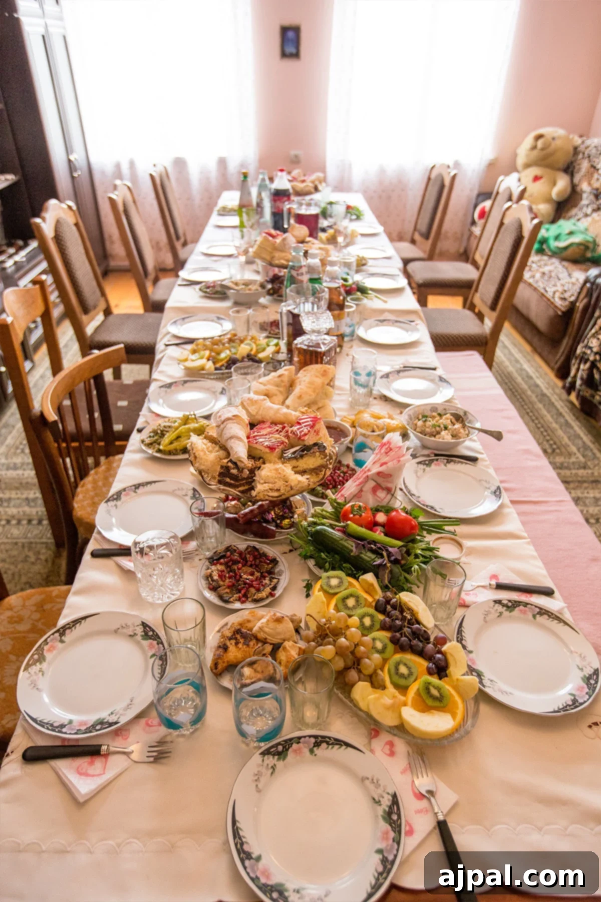 A beautifully set table for a traditional Georgian Supra, laden with various dishes and wine, signifying a festive meal.