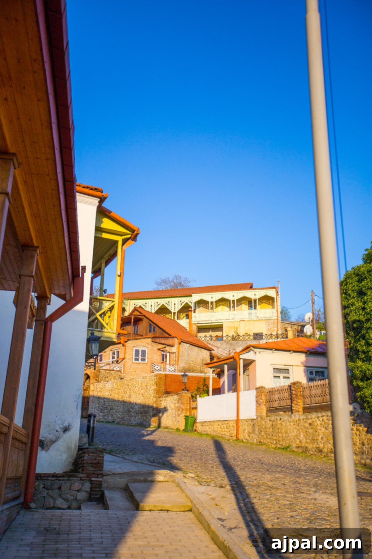 Charming cobblestone street in Sighnaghi, Georgia, under a clear blue sky