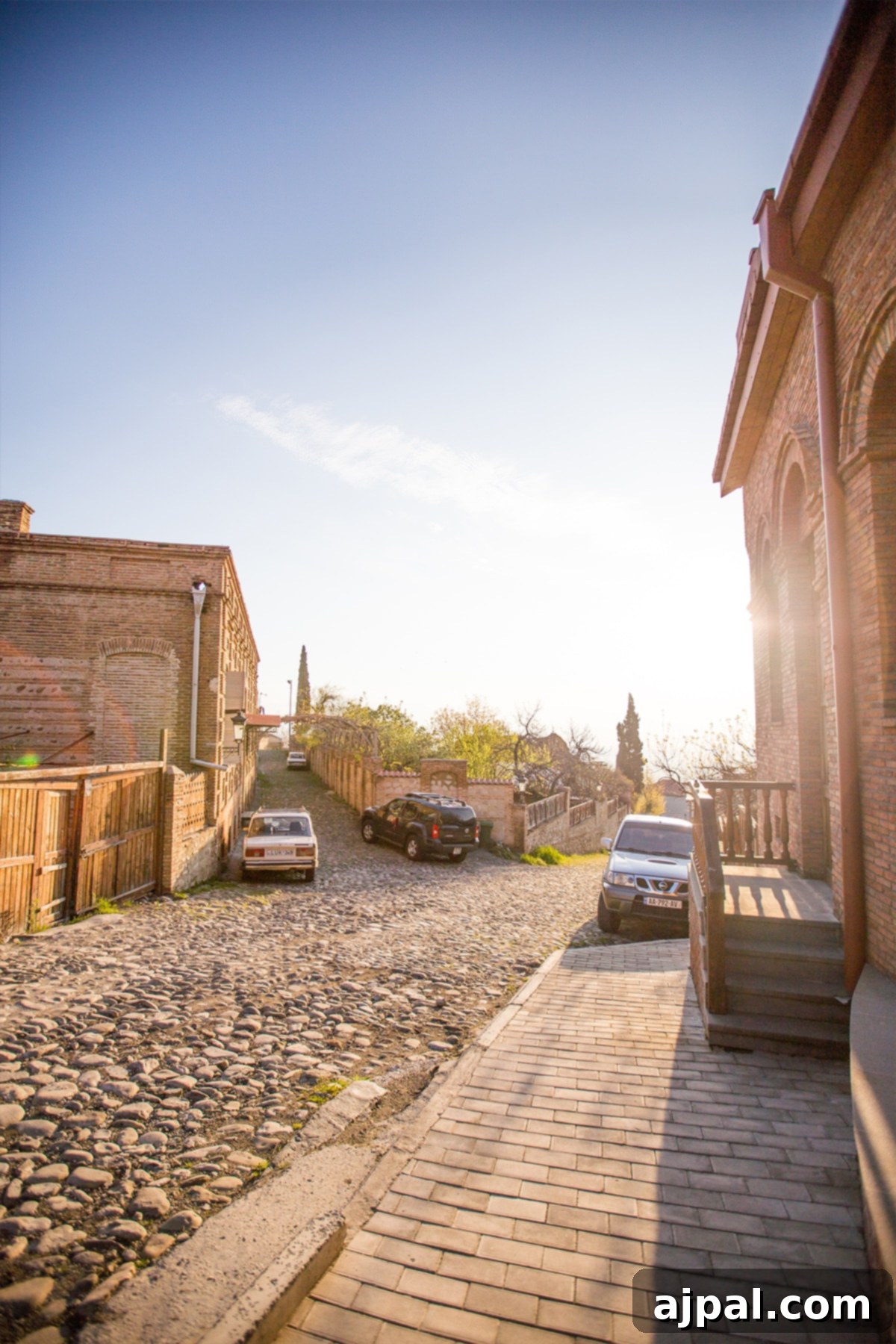 Sunset casting a golden glow on a cobblestone street in Sighnaghi, Georgia