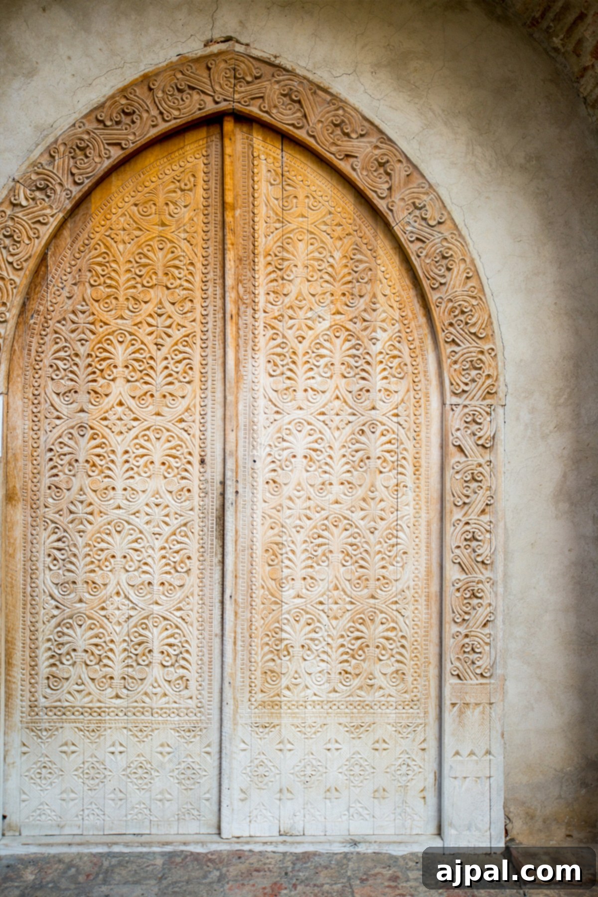 Ornate wooden door at Saint Nino's Bodbe Monastery, showcasing Georgian craftsmanship