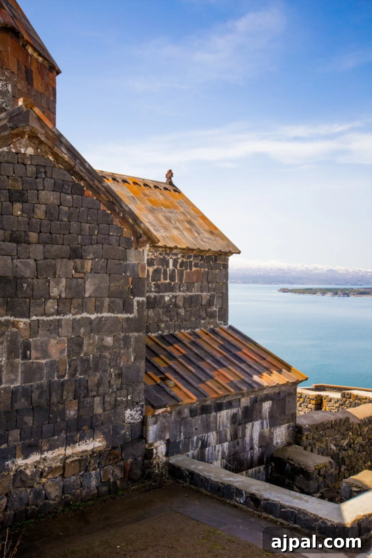 An ancient stone church of Sevanavank Monastery standing proudly by the tranquil waters of Lake Sevan in Armenia.