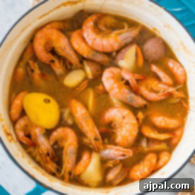 A quick and easy shrimp boil, this pot of shrimp stew features whole shrimp, sliced potatoes, and a whole lemon in a flavorful broth.