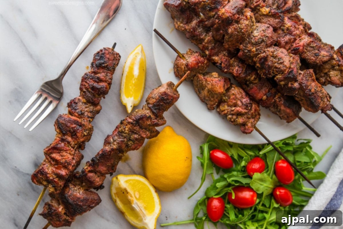The Ultimate Grilled Souvlaki 2 Grilled souvlaki skewers with lemon slices and tomatoes, a favorite summer meal