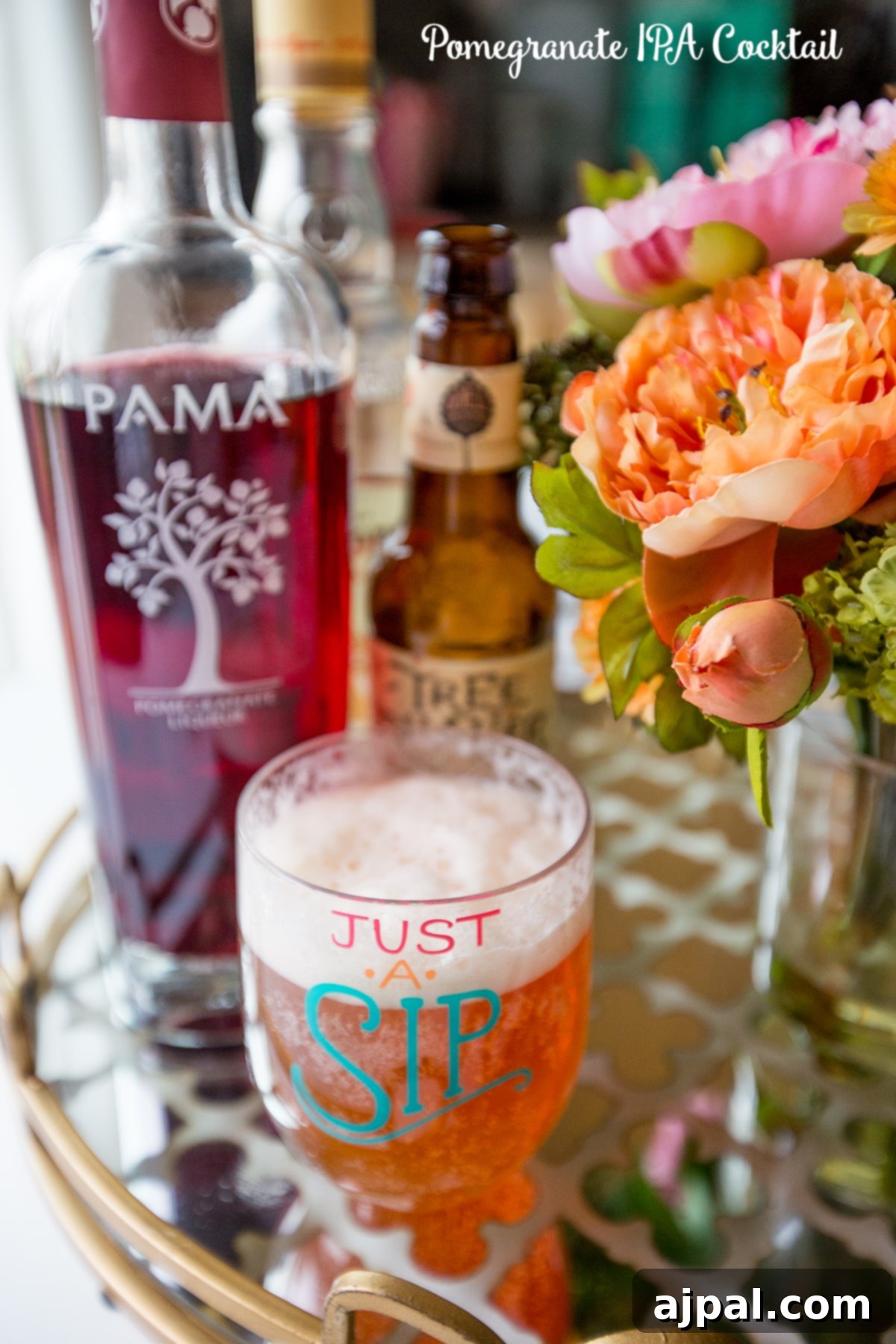 Ruby Brew-Rita 2 A vibrant Pomegranate IPA Cocktail, a delightful blend of pomegranate liqueur and IPA beer, served in a stylish glass, perfect for a summer party.